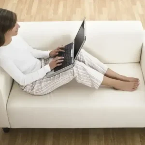 student comfortable on the couch using a laptop for a private tutoring real estate session